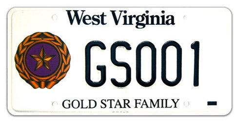 A West Virginia military specialty license plate honoring Gold Star Families, featuring a gold star and laurel wreath emblem on the left, 'GOLD STAR FAMILY' printed along the bottom, and sample registration GS001